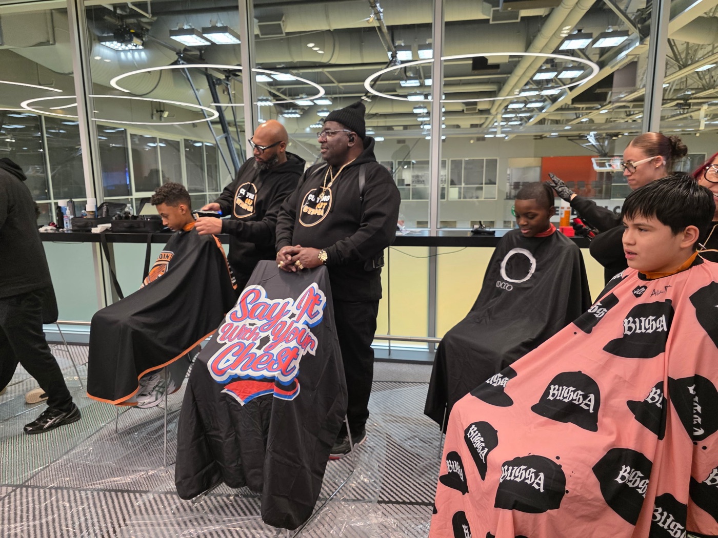 Big Steve and the DG team cutting hair at a community event