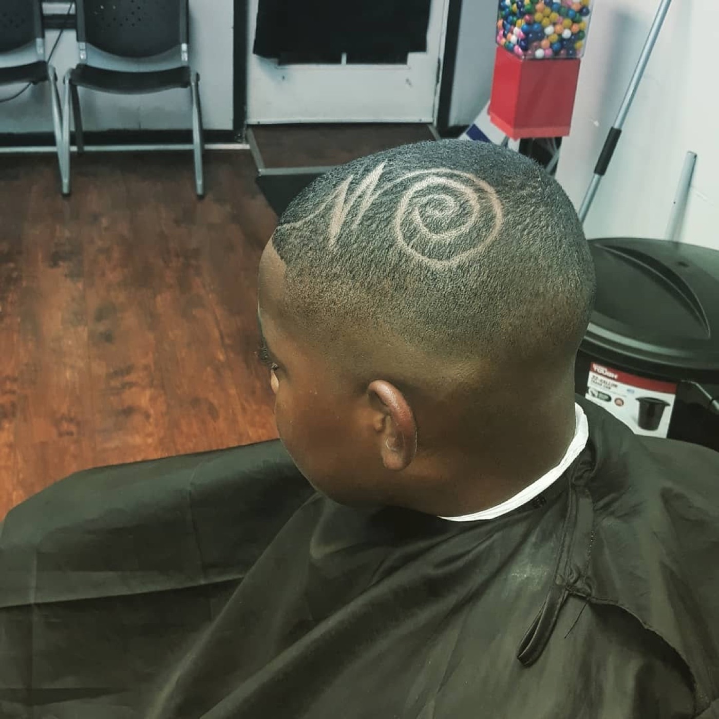 Kid's fade with a swirl hair design